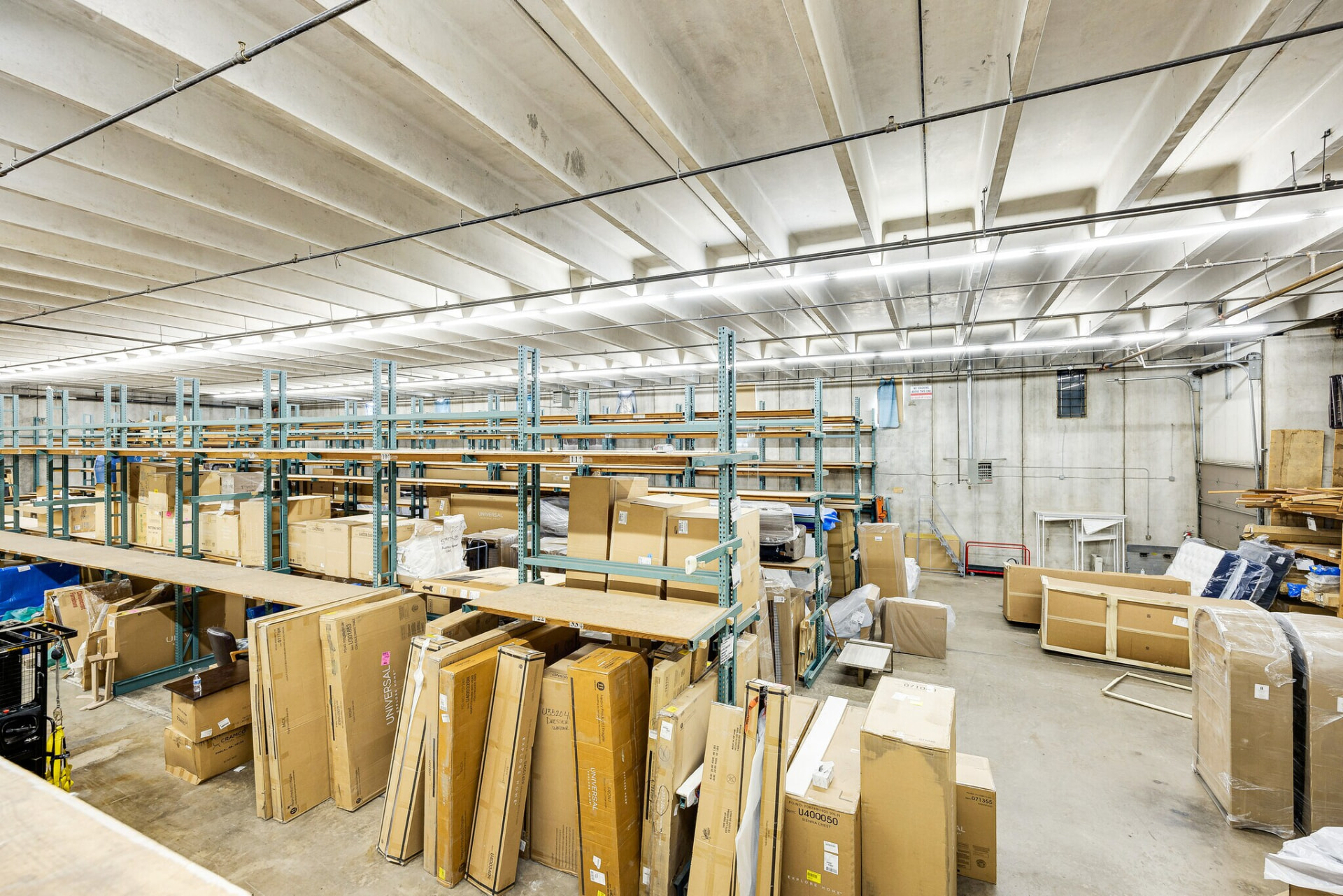Wide view of the rear storage area, racking system and interior overhead door.