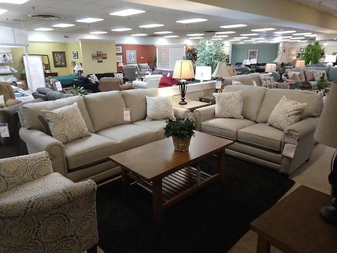 Showroom sight line across open floor toward the colored accent walls at the rear.