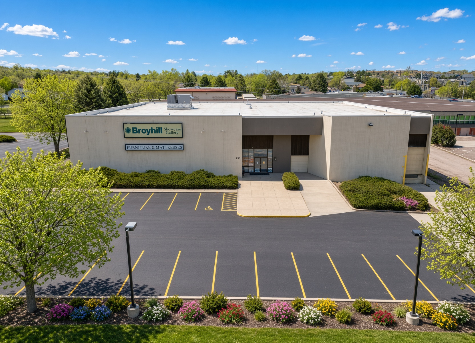 Elevated view of the front elevation, entrance and surface parking.